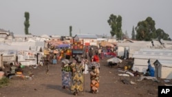 Women walk in the Bulengo refugee camp in Goma, Congo, after the World Health Organization had declared Aug, 15, 2024, the increasing spread of mpox in Africa a global health emergency.