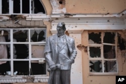 FILE - A damaged monument to Soviet founder Vladimir Lenin stands in a central square in the Kursk region town Sudzha, Russia, Aug. 16, 2024. This image was approved by the Ukrainian Defense Ministry before publication.