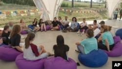 First lady Olena Zelenska talks with children during her visit to the rehabilitation camp "Loud Camp" for children affected by war in Uzhhorod, Ukraine, Aug. 27, 2024.