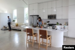 Lawrence Nourzad and Angela Hontas spend time in their newly purchased 3D-printed home in Georgetown, Texas, June 26, 2024.