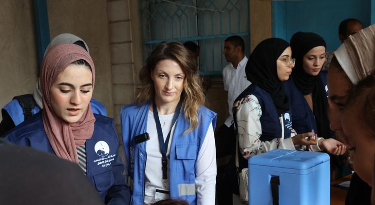 Louise Wateridge, UNRWA Spokesperson (middle) following the administering of polio vaccination in UNRWA's Deir El Balah health center. 