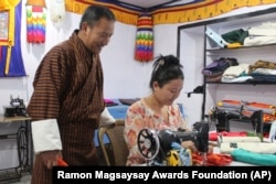 This undated photo provided by the Ramon Magsaysay Award Foundation shows 2024 Ramon Magsaysay Awardee, Karma Phuntsho, left, from Bhutan. (Ramon Magsaysay Awards Foundation via AP)