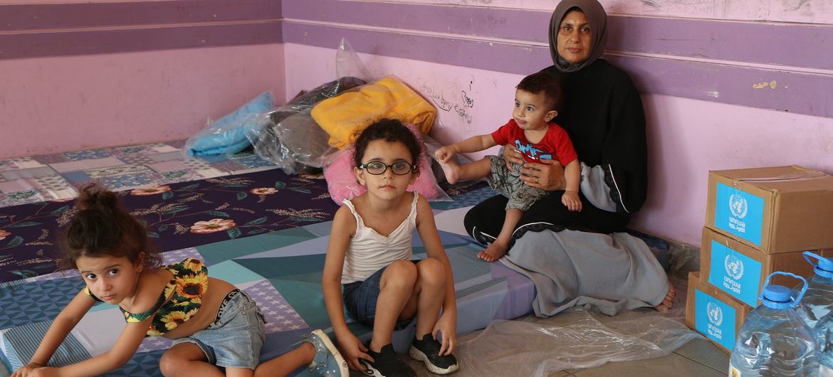 A family takes refuge in an emergency shelter opened by the UN following missile strikes by Israel on Lebanon.