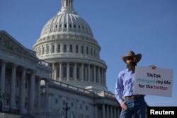 FILE - Brian Firebaugh of Hubbard, Texas, protests at the U.S. Capitol following a press conference by TikTok creators to voice opposition to legislation seeking to crack down on the social media platform, in Washington, March 12, 2024.