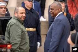 U.S. Secretary of Defense Lloyd Austin, right, greets Ukrainian Defense Minister Rustem Umerov as he arrives for a meeting at the Pentagon on Aug. 30, 2024, in Washington.