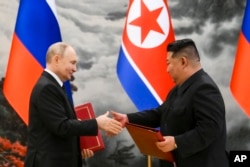 FILE - Russian President Vladimir Putin, left, and North Korea's leader Kim Jong Un exchange documents during a signing ceremony of the new partnership in Pyongyang, North Korea, June 19, 2024. (Kristina Kormilitsyna, Sputnik, Kremlin Pool Photo via AP)