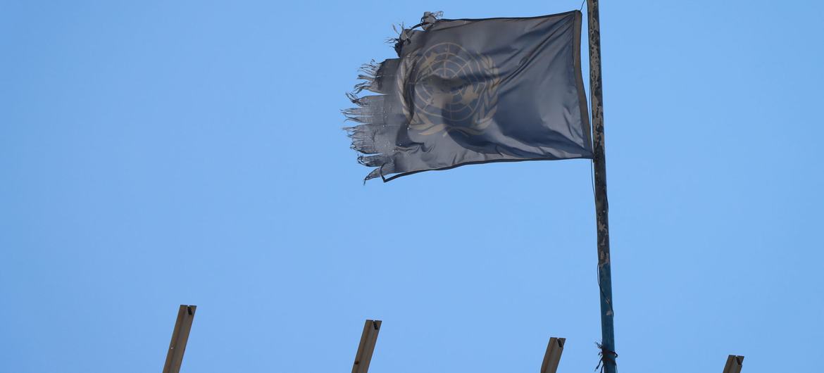 A shredded UN flag flies over a destroyed school building in Khan Younis.