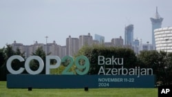 FILE - A sign for COP29, the United Nations Climate Change Conference, is on display in Baku, Azerbaijan, Sept. 16, 2024.