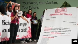 FILE - Activist Teresa Anderson leads a demonstration calling for climate finance during the COP29 U.N. Climate Summit, Nov. 14, 2024, in Baku, Azerbaijan.