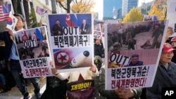 FILE - Demonstrators stage a rally against the recent alleged deployment of North Korean troops to Russia, near the Seoul Central District Court in Seoul, South Korea, Nov. 15, 2024. The signs read 