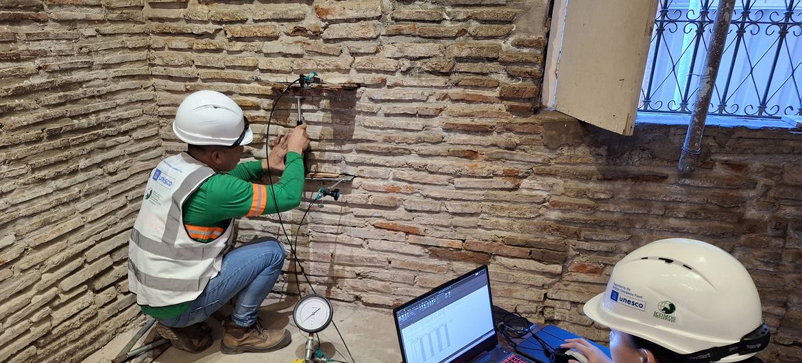 Technicians assess the structure of an historic building in Vigan.