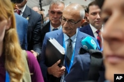 John Podesta, U.S. climate envoy, walks through a crowd during the COP29 U.N. Climate Summit on Nov. 23, 2024, in Baku, Azerbaijan.