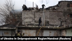 Firefighters work at the site of a Russian missile strike, amid Russia's attack on Ukraine, in Dnipro, Ukraine, Nov. 21, 2024.