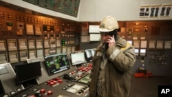 A worker speaks by mobile phone inside operating room at DTEK's power plant after a recent Russian missile attack in Ukraine, Nov. 28, 2024.