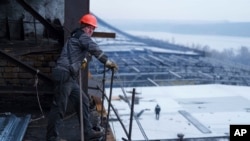 A worker stands on a roof of a DTEK's power plant after a recent Russian missile attack in Ukraine, Nov. 28, 2024.