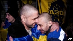 Scores of Ukrainian and Russian prisoners head back home after swap