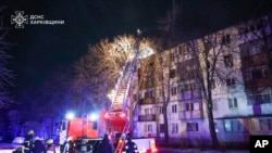 FILE - In this photo provided by the Ukrainian Emergency Service, firefighters work on the site of a damaged building after a Russian drone attack in Kharkiv, Ukraine, early Dec. 13, 2024. (Ukrainian Emergency Service via AP Photo)