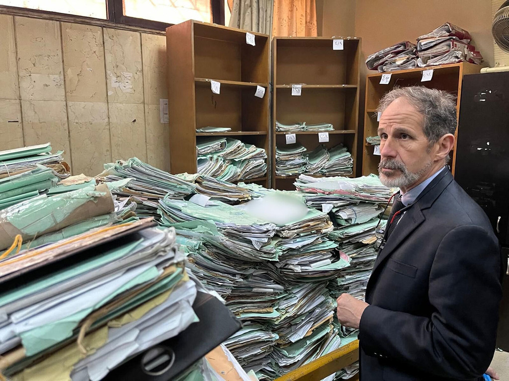 Documents are piled up at a court house in Damascus, Syria, which was visited by the head of the IIIM, Robert Petit.