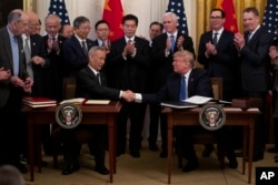 As tariffs take effect, Beijing and Washington look back to 2020 deal