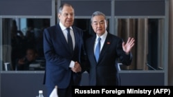 FILE - Russian Foreign Minister Sergey Lavrov meets with China's Foreign Minister Wang Yi on the sidelines of the G20 Foreign Minister Meeting in Johannesburg, Feb. 20, 2025.