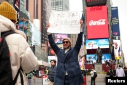 A social media influencer films a video for his new Xiaohongshu, also known as RedNote, after leaving TikTok, in Times Square in New York City, Jan. 16, 2025.