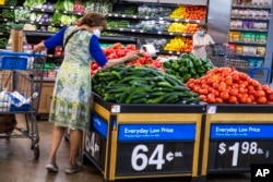 FILE - People buy groceries at a Walmart Superstore in Secaucus, N.J., July 11, 2024.