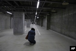 Reporters see one of the underground passageways that connect all the buildings in Toyota’s Woven City, Japan, Feb. 22, 2025.