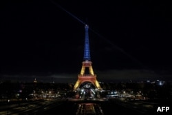 The Eiffel Tower is lit in the colors of the Ukrainian flag to mark the third anniversary of the invasion by Russia of Ukraine, in Paris, on Feb. 24, 2025.