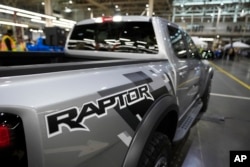 A 2024 Ford F-150 Raptor truck is displayed at the Dearborn Truck Plant, on April 11, 2024, in Dearborn, Michigan. Ford and General Motors are two companies that could be hit hard by Chinese tariffs, experts say.