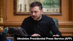 Ukraine's President Volodymyr Zelenskyy speaks during a phone call with the U.S. president while sitting at his office in Kyiv, amid the Russian invasion of Ukraine, Feb. 12, 2025.